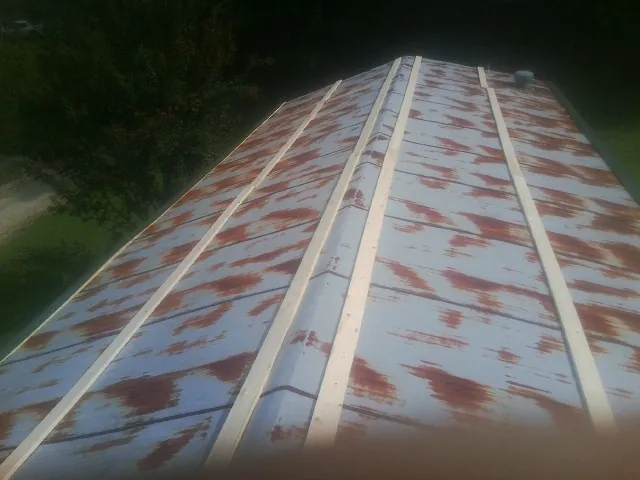 Rusted metal roof panels with new wood purlins before replacement — Storm Damage Roof Repair in Weston by Roofing Brothers